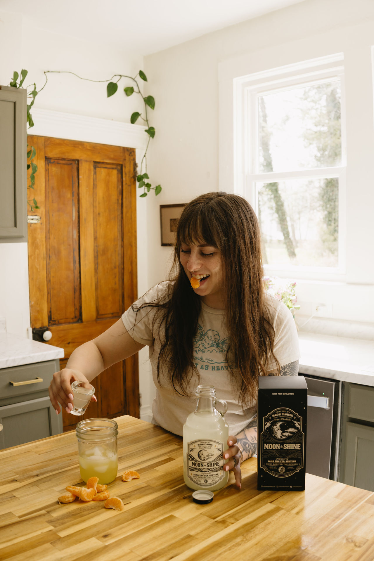 Thc Moonshine Woman with brown hair enjoying malicious herself a thc mocktail with moon flower moon shine from natural Healthy cbd